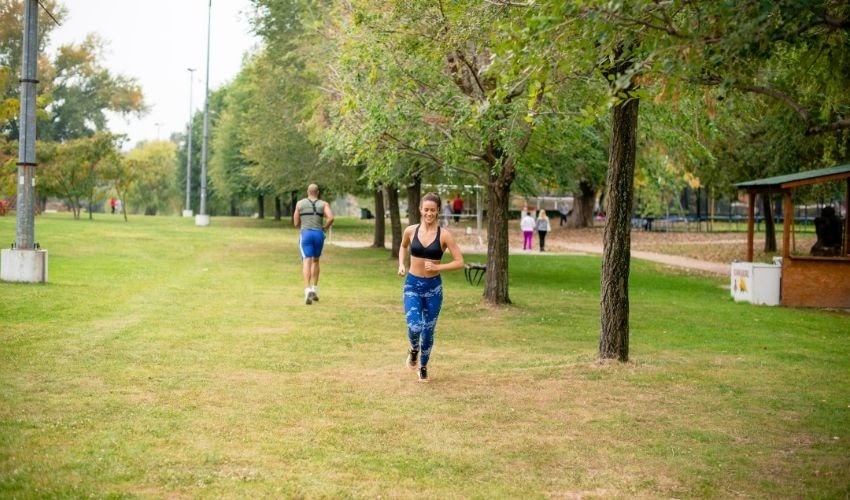 girl jogging in local park