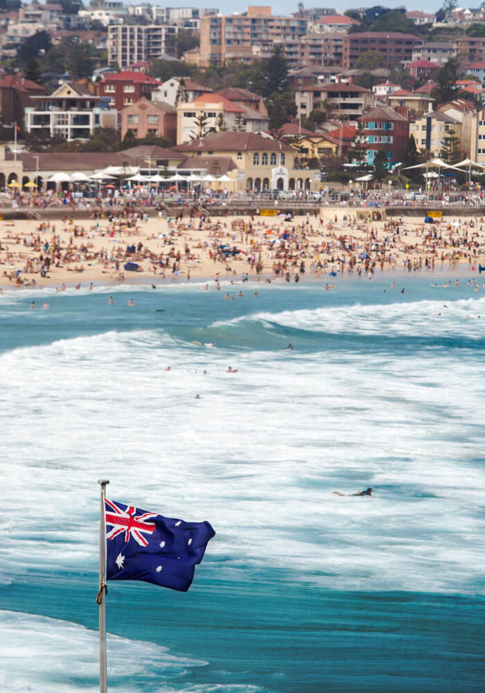 vertical-shot-australian-flag-sea-crowded-bondi-beach